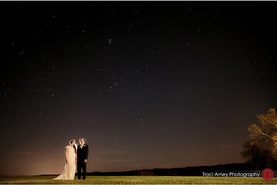 Couple standing on grass with a starry dusk sky at Willow Oaks Plantation in Eden, NC