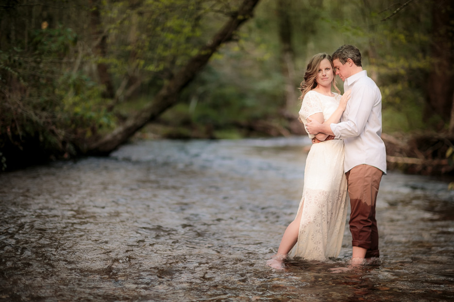 Couple embracing each other standing in a river at the Pisgah National Forest in Ashville, NC