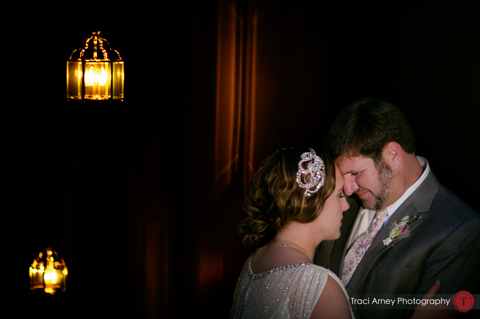 bride and groom in softly lit but graphic dark stairwell
