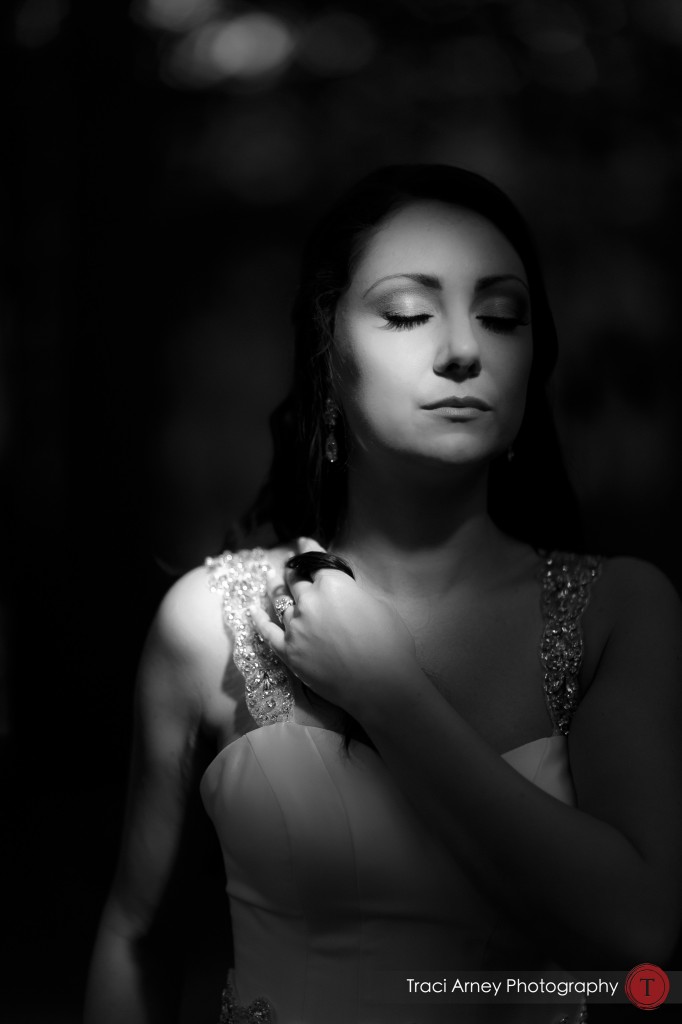 black and white of bride with eyes closed and stream of sunlight on her face