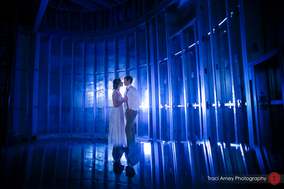 Bride and groom in blue lit silo during their romance from their outdoor wedding at Summerfield Farms, Summerfield, NC
